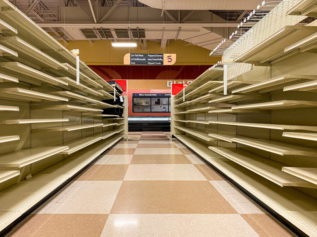 The aisles of a local grocery store chain sits empty after the store announced it was liquidating all remaining stock and closing down.